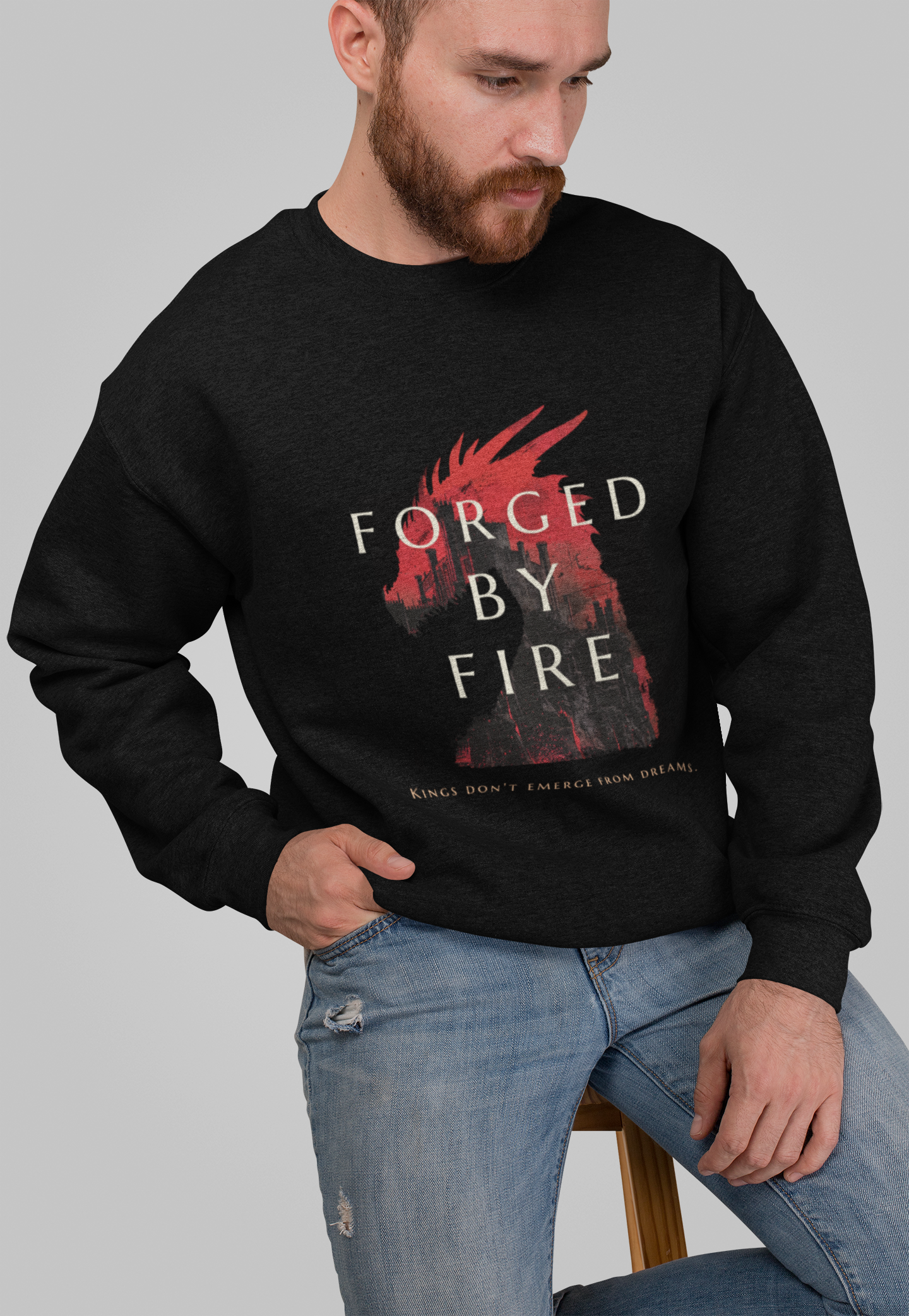 A man wearing a black sweatshirt with 'FORGED BY FIRE' text and a graphic on the front.