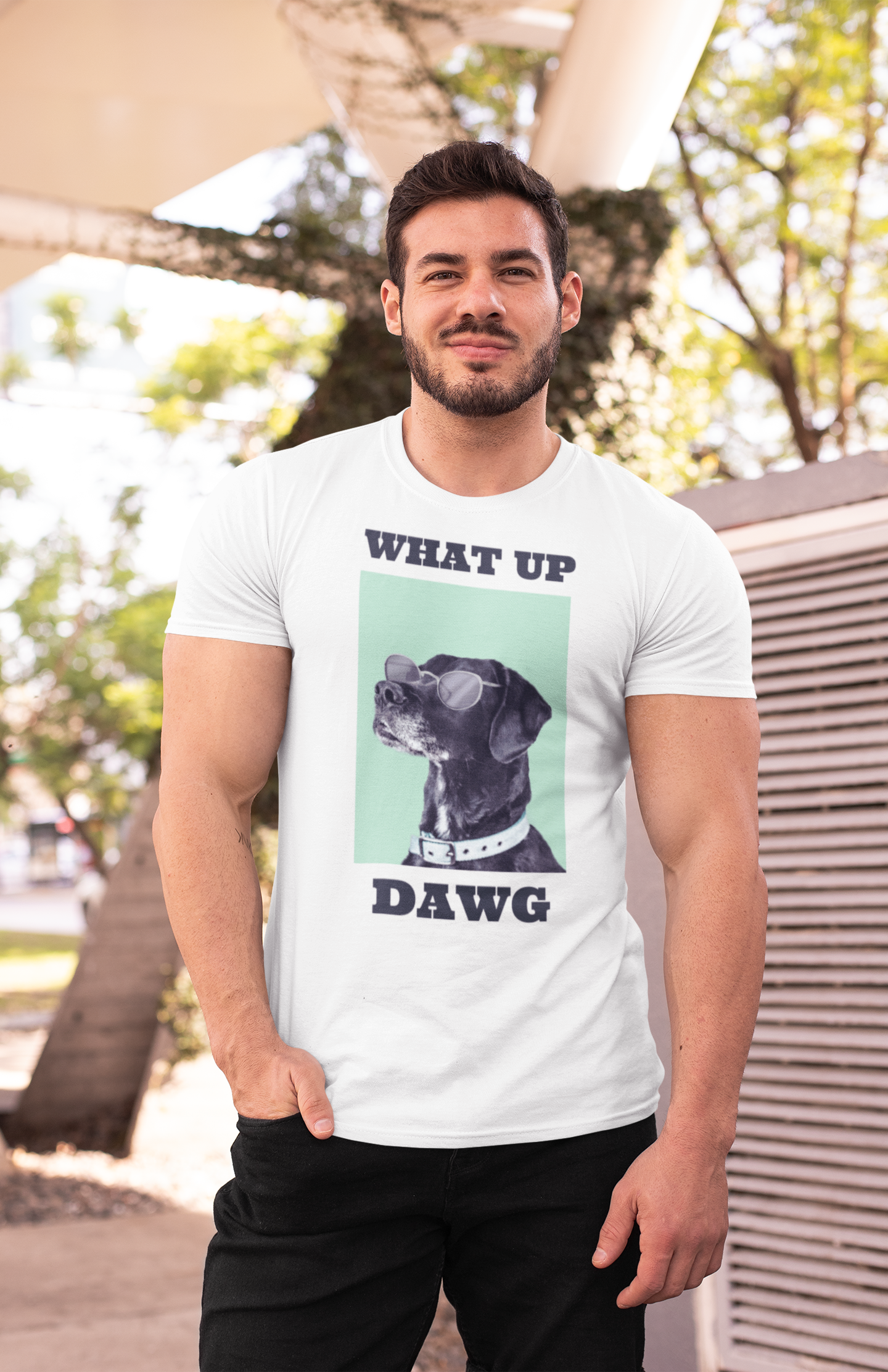 A man wearing a white crew neck t-shirt with a graphic that includes the text 'WHAT UP DAWG' and an image of a dog.