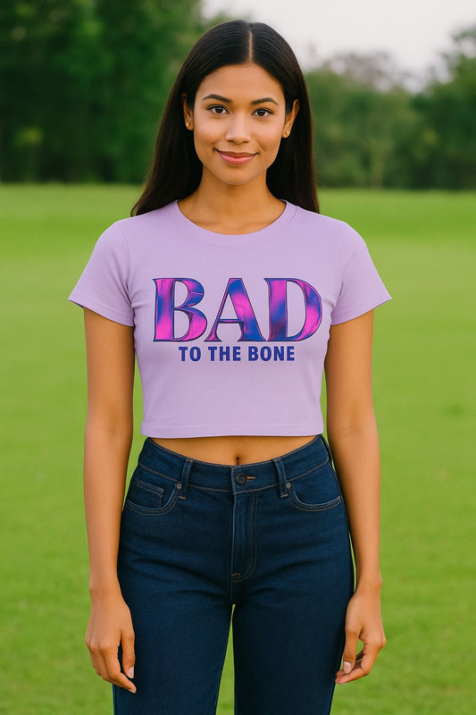 Person wearing a purple t-shirt with 'BAD TO THE BONE' text outdoors.
