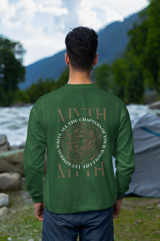 Person wearing a green 'MYTH' branded long-sleeve shirt with a mountainous landscape in the background.