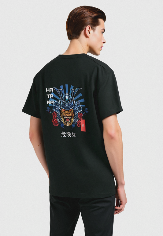 A person wearing a black oversized t-shirt with a graphic print of a samurai helmet on the back.