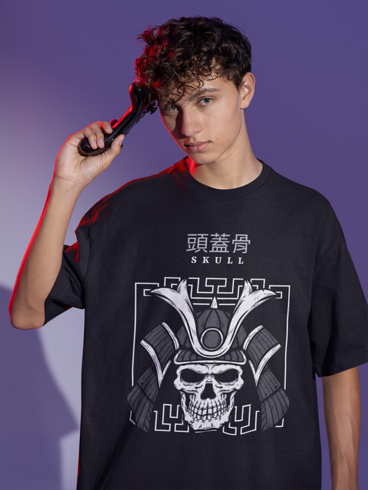 A person with curly hair is posing with a hand through their hair, wearing a black oversized t-shirt with a white graphic of a skull and Chinese characters.