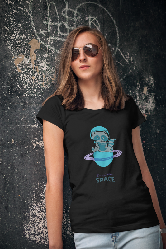A woman wearing a black t-shirt with a graphic design of a character in space gear and the text 'SPACE' below it.