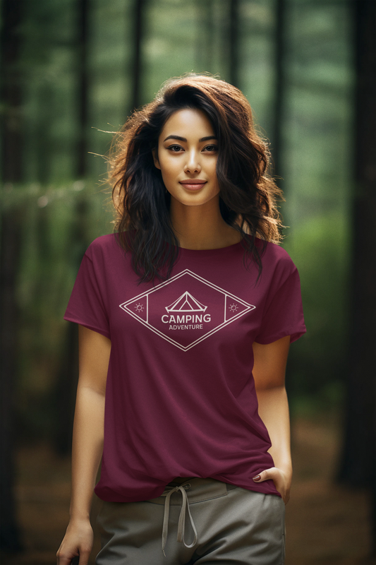 Woman wearing a purple t-shirt with a camping logo in a forest setting