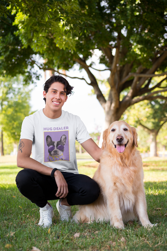 Man in a white t-shirt with a dog in a park