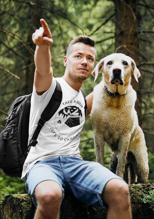 Man with a dog sitting on a log in a forest ..man with white t shirt which as take a break quote