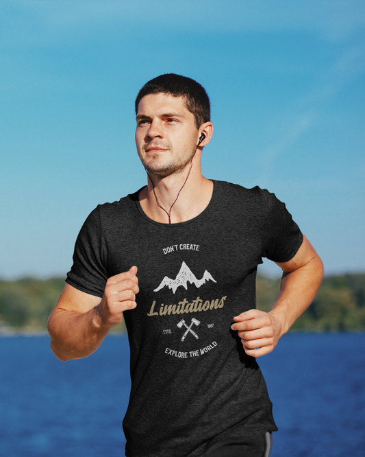 Man wearing a black t-shirt with motivational quote outdoors by water